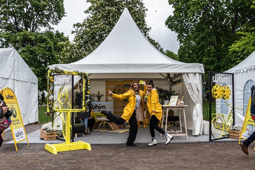 Picture of Whim's tent and two people in yellow raincoats