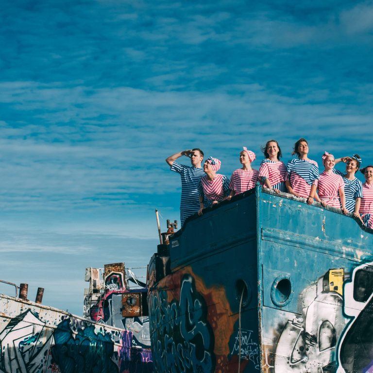 People in striped clothes on a ship.