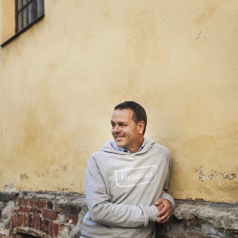Jan Vapaavuori wearing a gray hoodie that says "Helsinki".