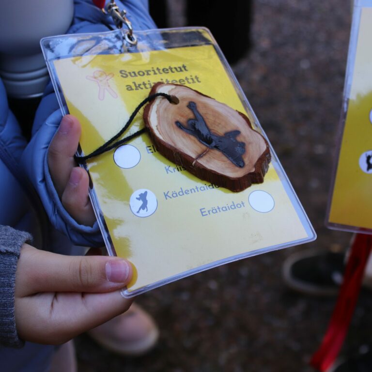 An activities pass held by a child.