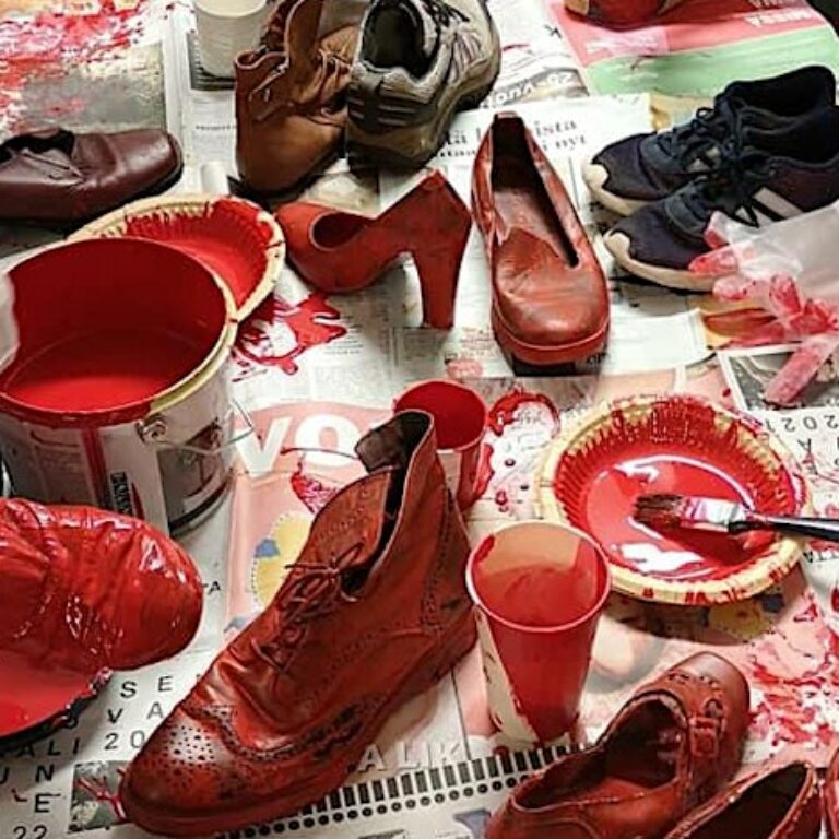 Painting red shoes.